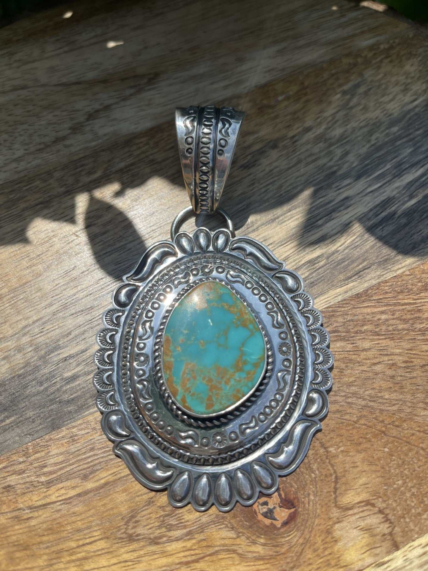 Native American Pilot Mountain Turquoise pendant with silver ornate setting by Roland Dixson
