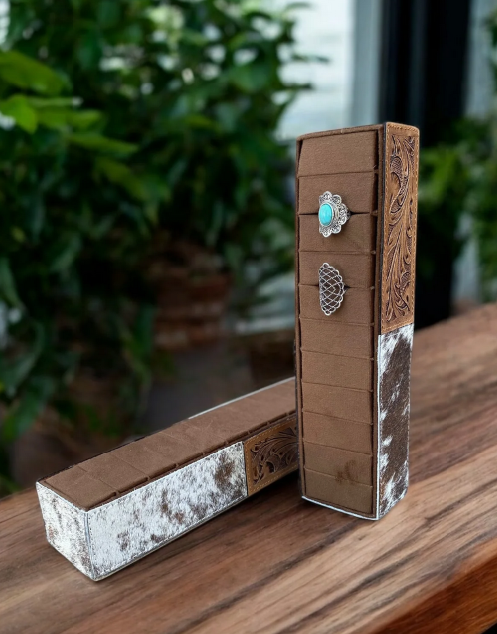 Cowhide and tooled leather ring holder with rustic charm and elegant craftsmanship.