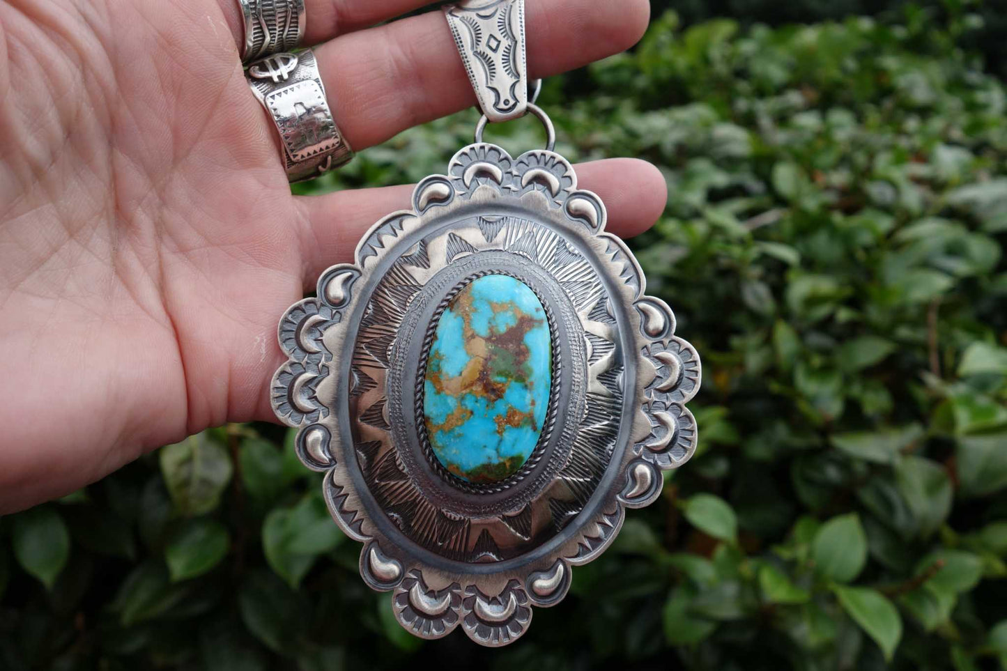 Royston Turquoise Pendant with intricate silver design and vibrant turquoise stone.