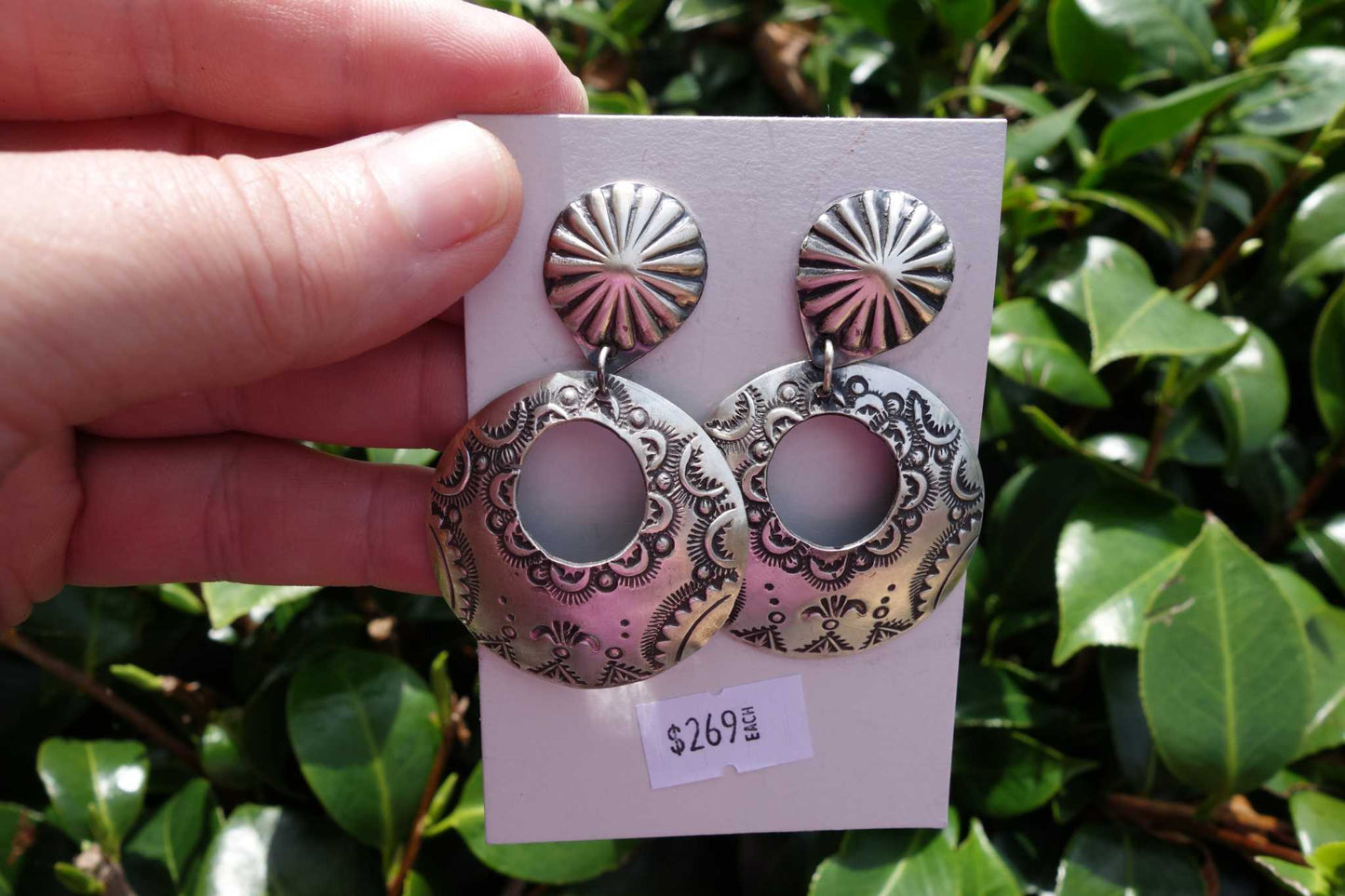 Handmade Vincent Platero stamped sterling silver round earrings with intricate designs, 2 5/16 inches long, displayed on a card with price tag.