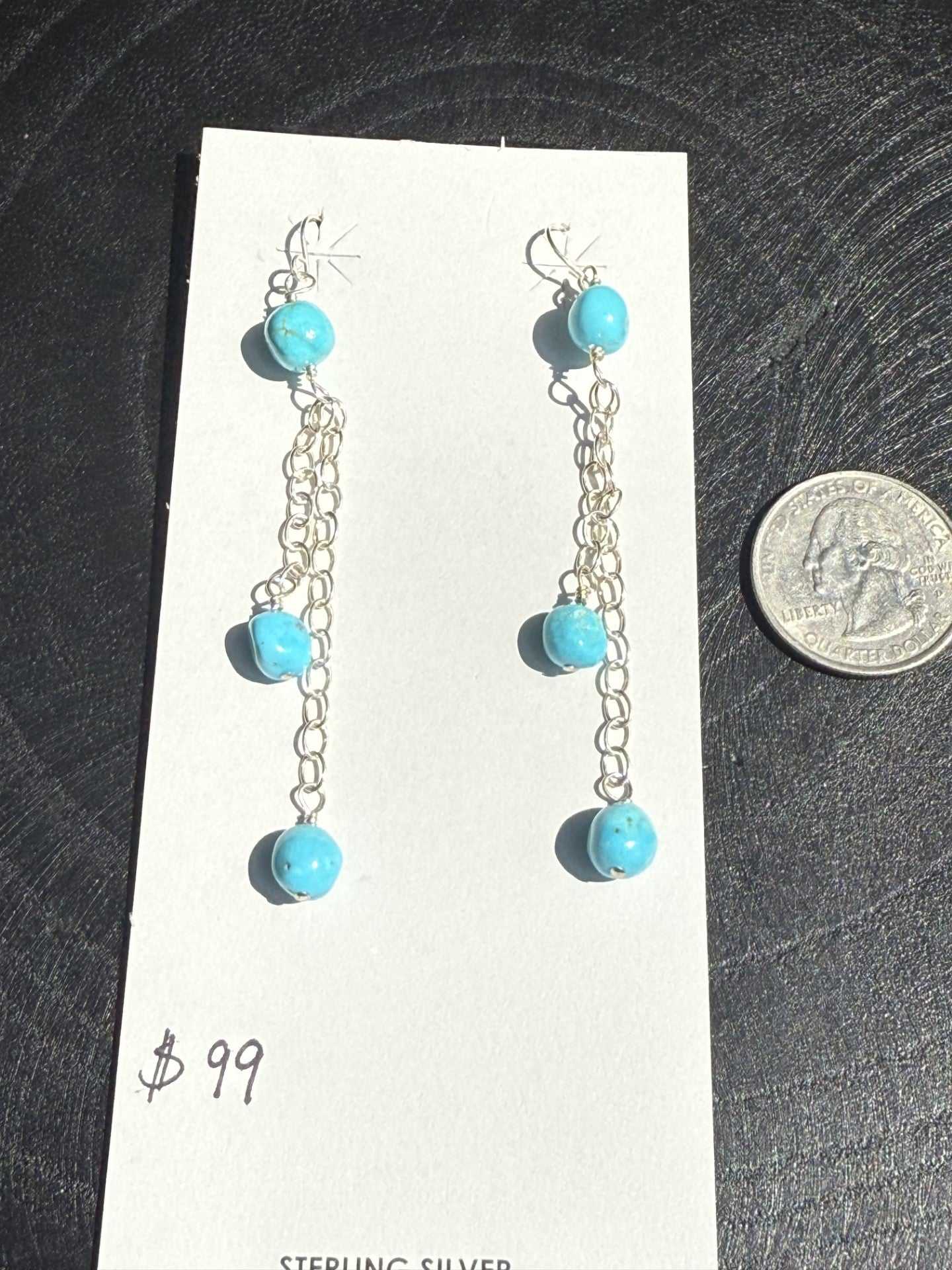 Sterling silver chain dangle earrings with Kingman turquoise balls, 3 inches long, displayed on white card.