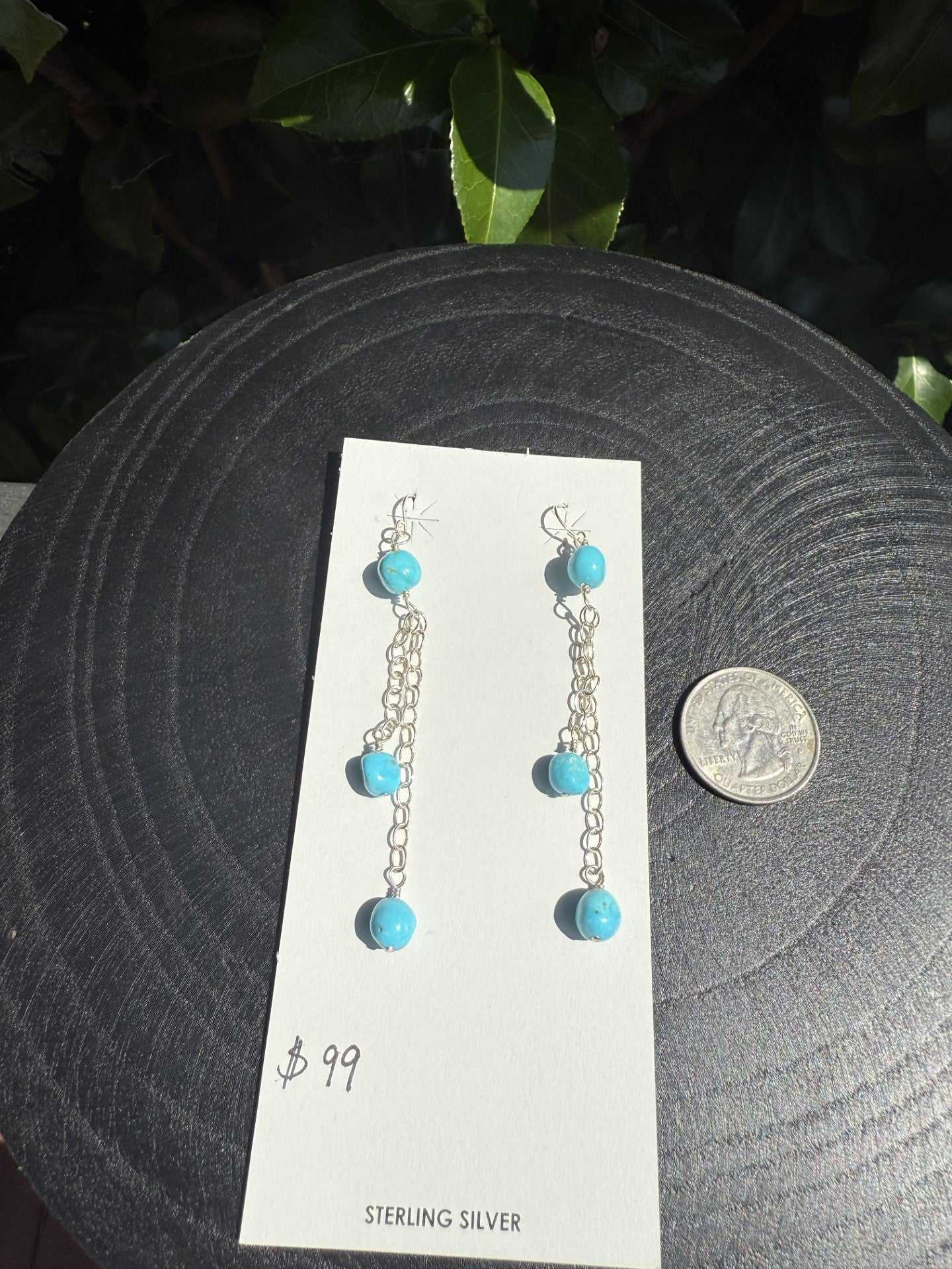 Sterling silver chain dangle earrings with Kingman turquoise balls by Navajo artist, 3 inches long, displayed with a quarter for scale