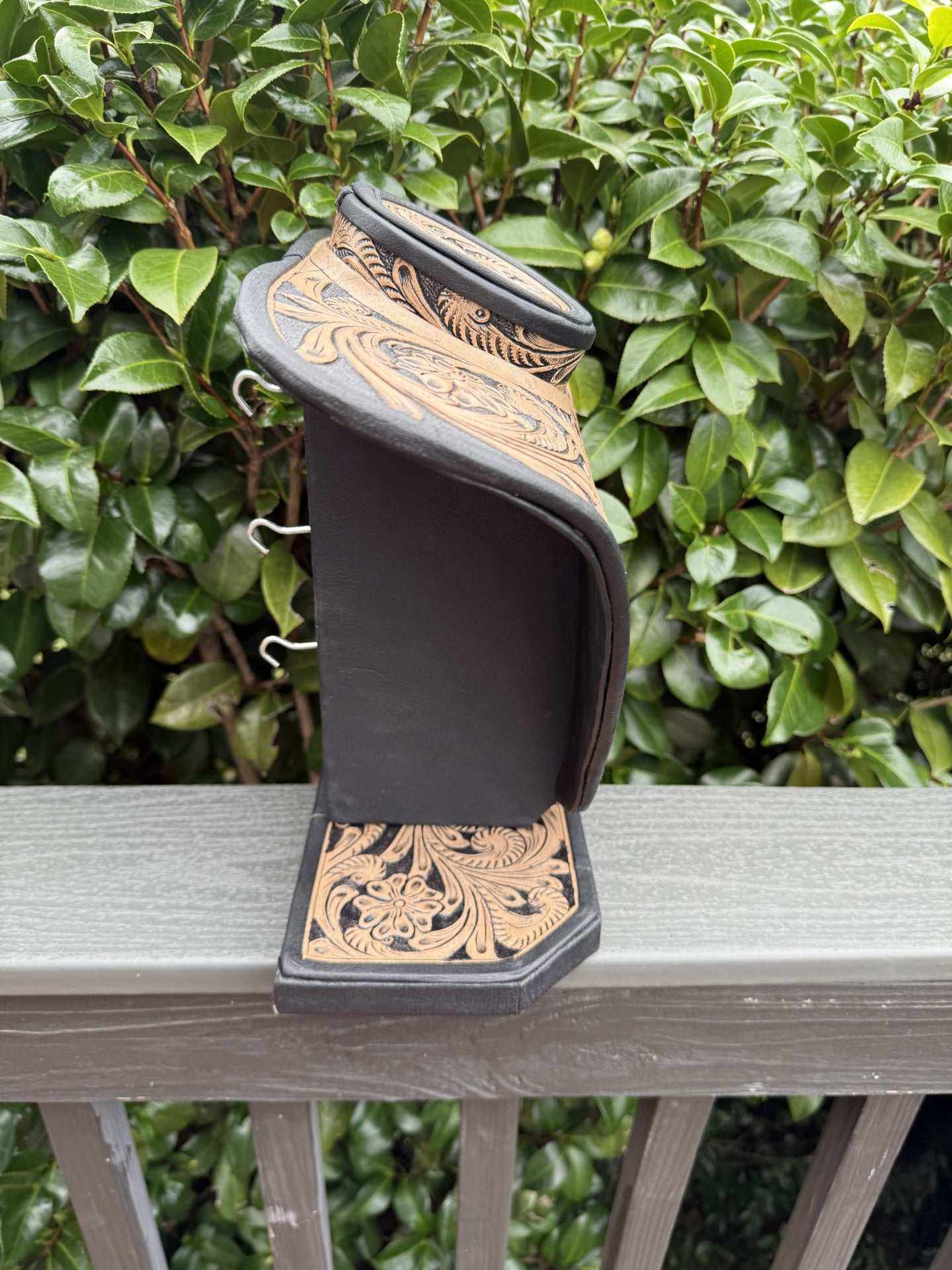 Beige and brown all tooled leather necklace display with intricate floral design for elegant jewelry presentation