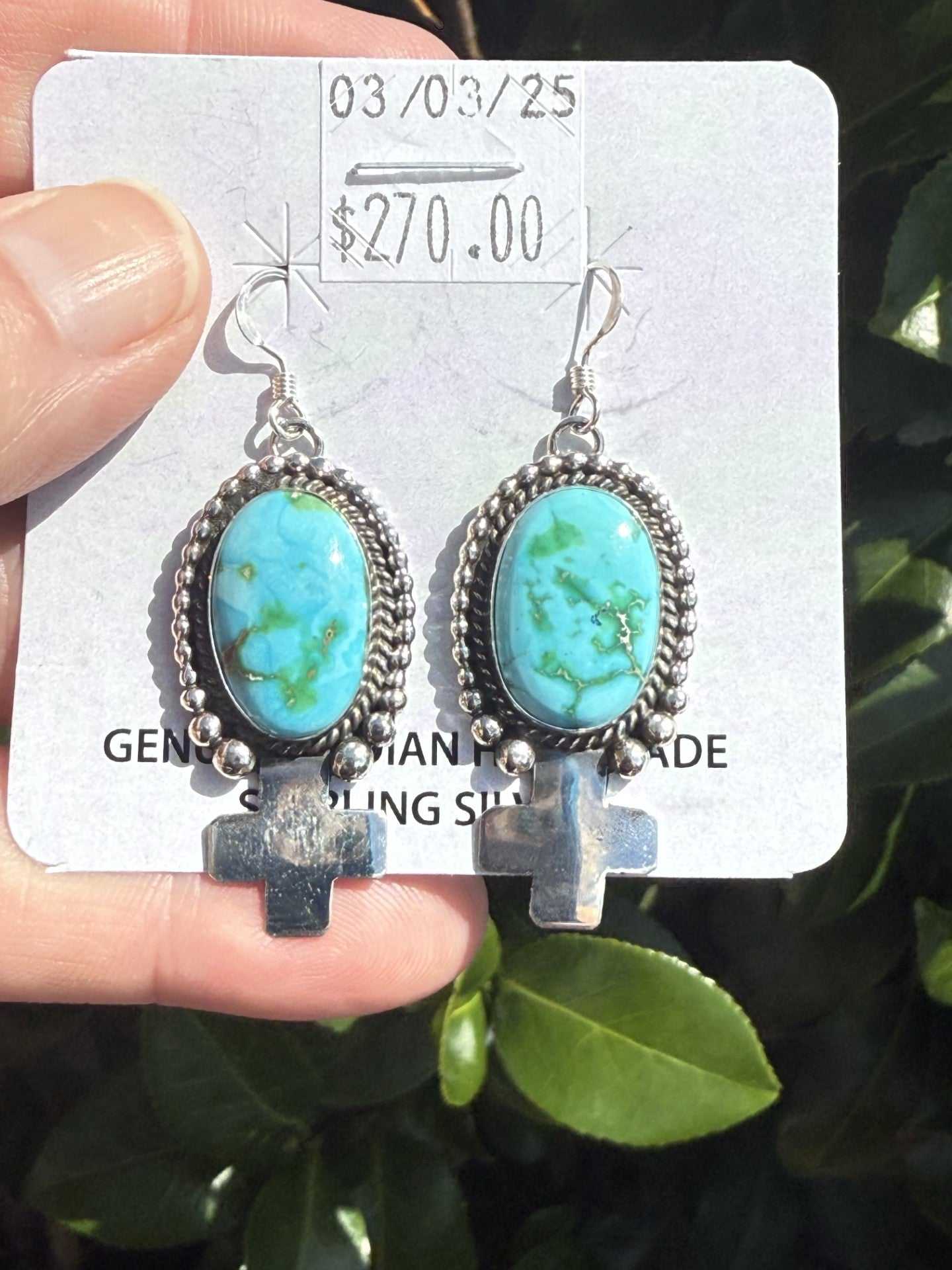Handcrafted Navajo sterling silver Sonoran Turquoise Earrings with oval blue-green turquoise stones and cross dangles.