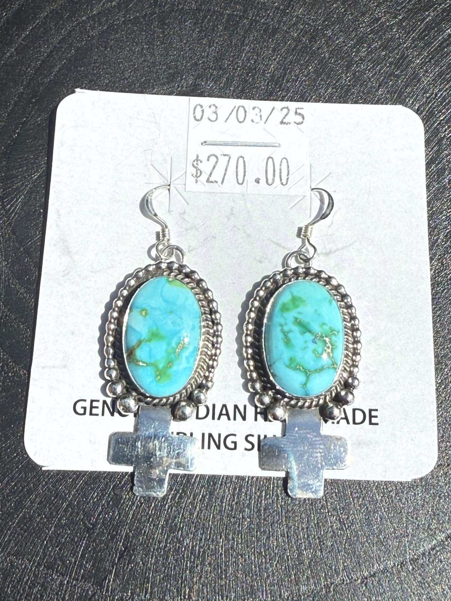 Sterling silver Sonoran Turquoise Earrings with blue-green stones and Zia cross dangle handcrafted by Navajo silversmith.