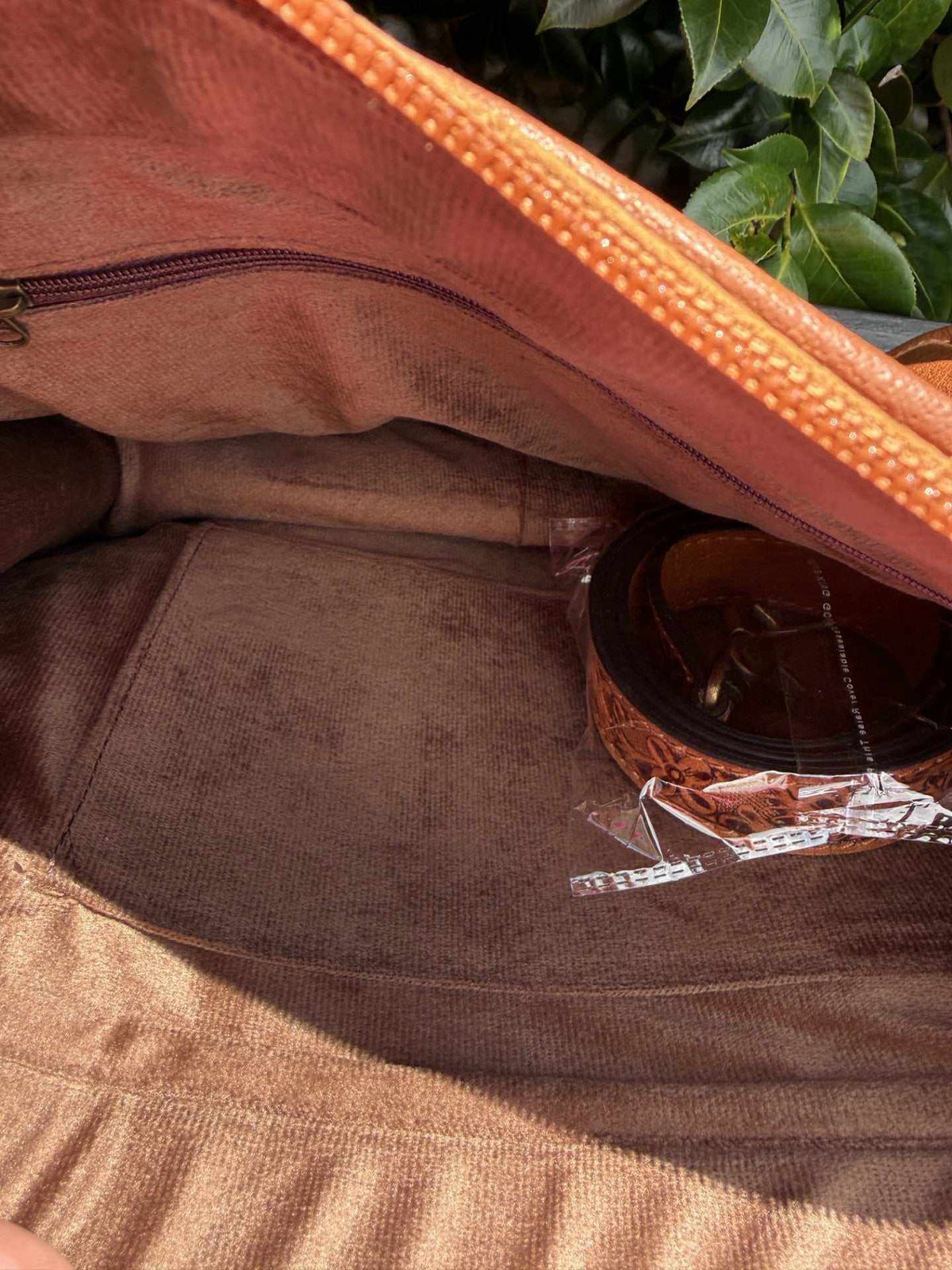 Deer tooled leather tote bag in tan and brown leather, showing a zippered inner pocket and roomy fabric-lined interior