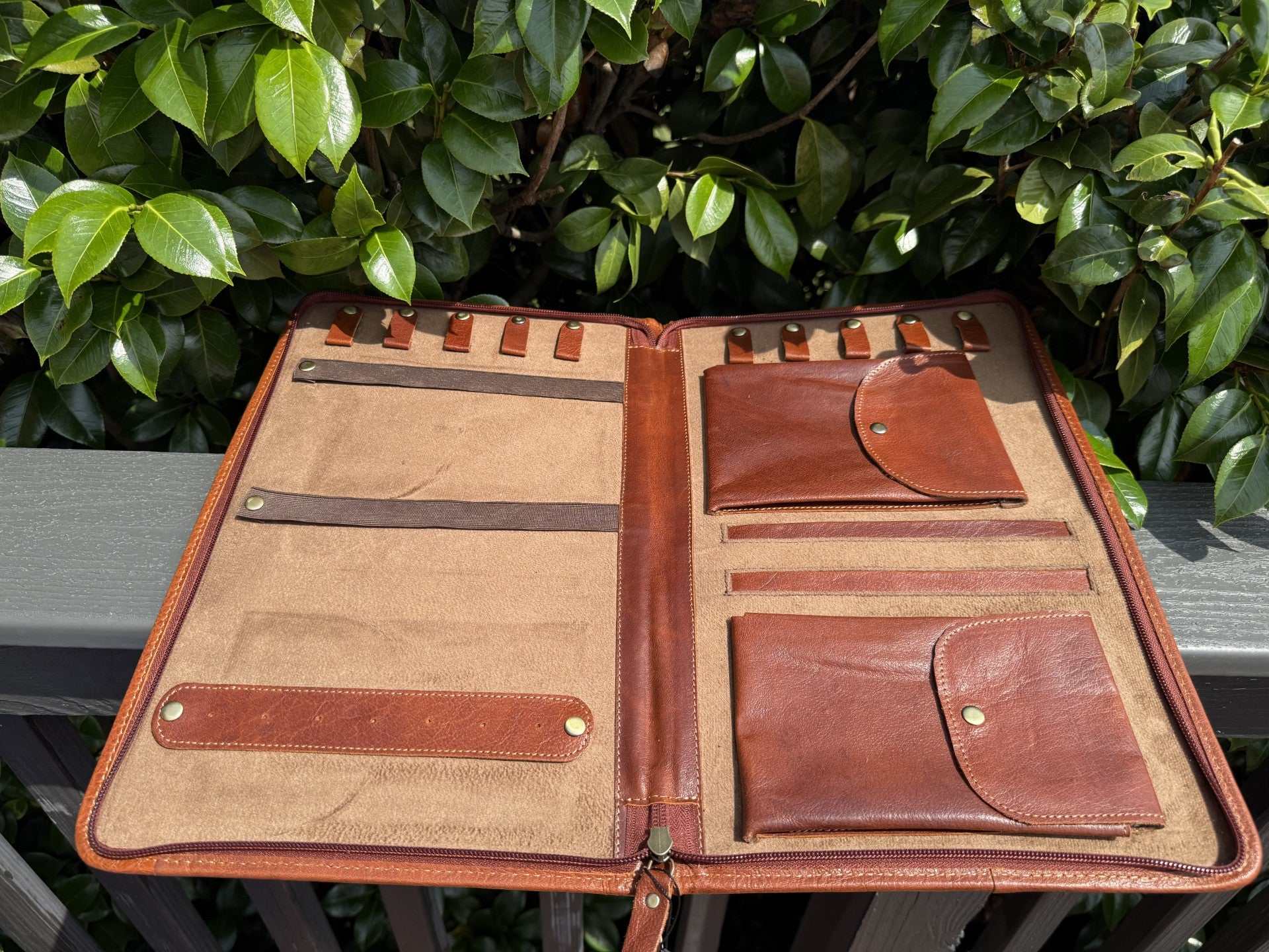 Jewelry wallet in tooled leather with western design, crafted from genuine cowhide for stylish jewelry storage and travel.