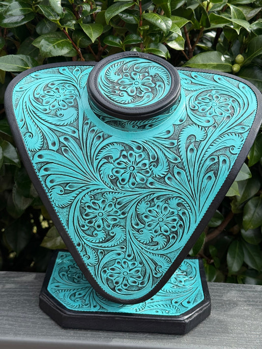 Turquoise and brown all tooled leather necklace display with intricate floral patterns and elegant craftsmanship