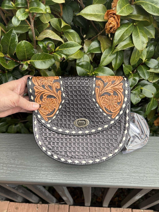 Black tooled leather crossbody bag with brown and white detailing, handmade and versatile accessory