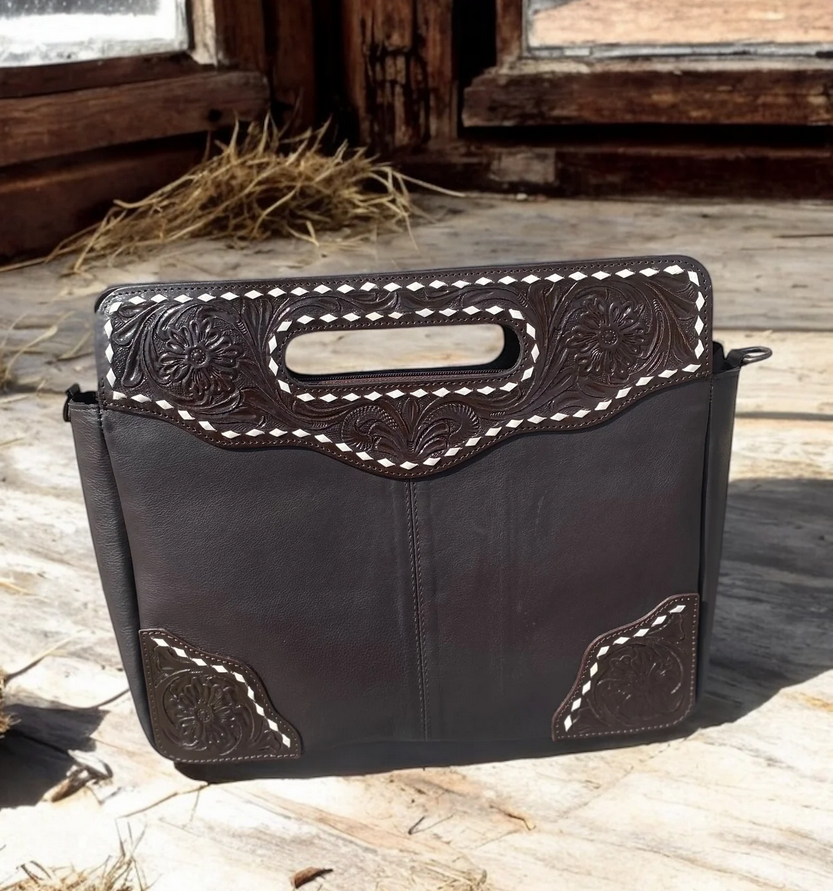 Handcrafted tooled leather crossbody purse with intricate design.