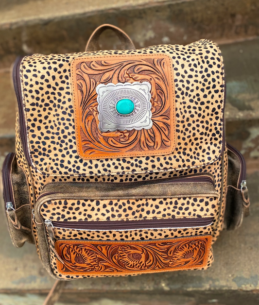 Cheetah Print Stone Backpack made of genuine cowhide with adjustable straps.