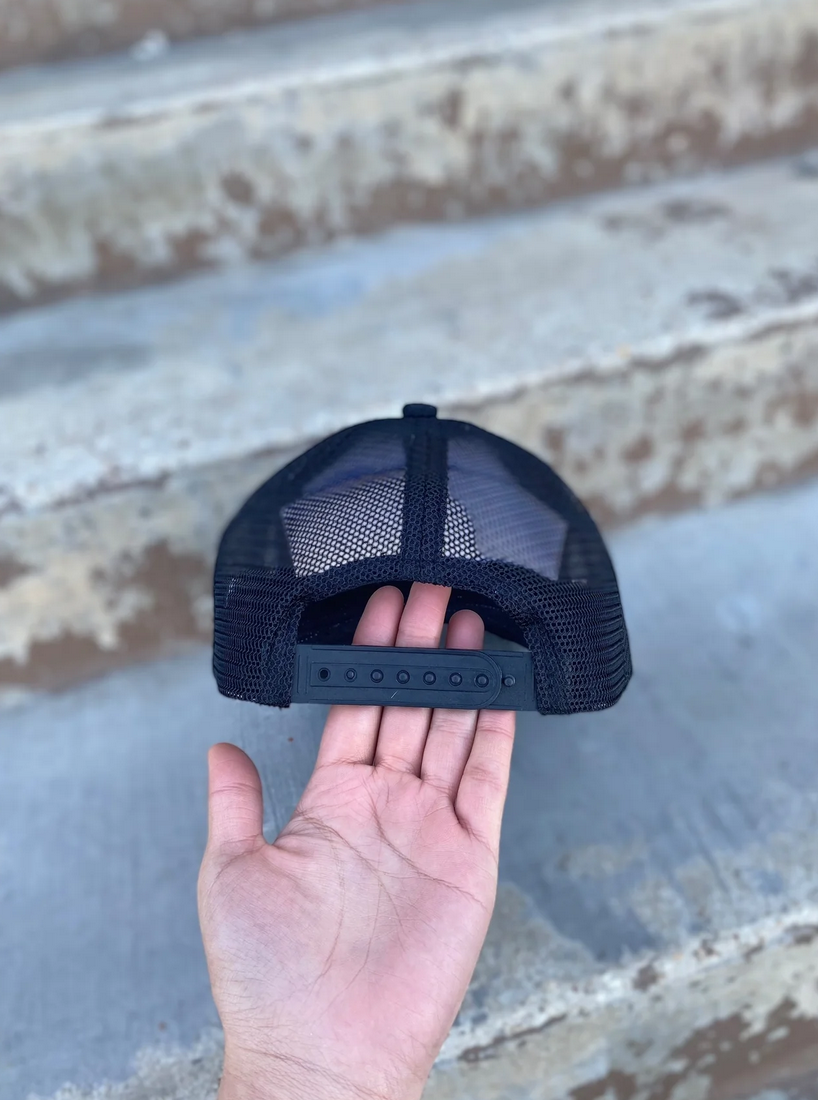 Back view of adjustable black mesh western hat with cowhide tooled leather front panel.