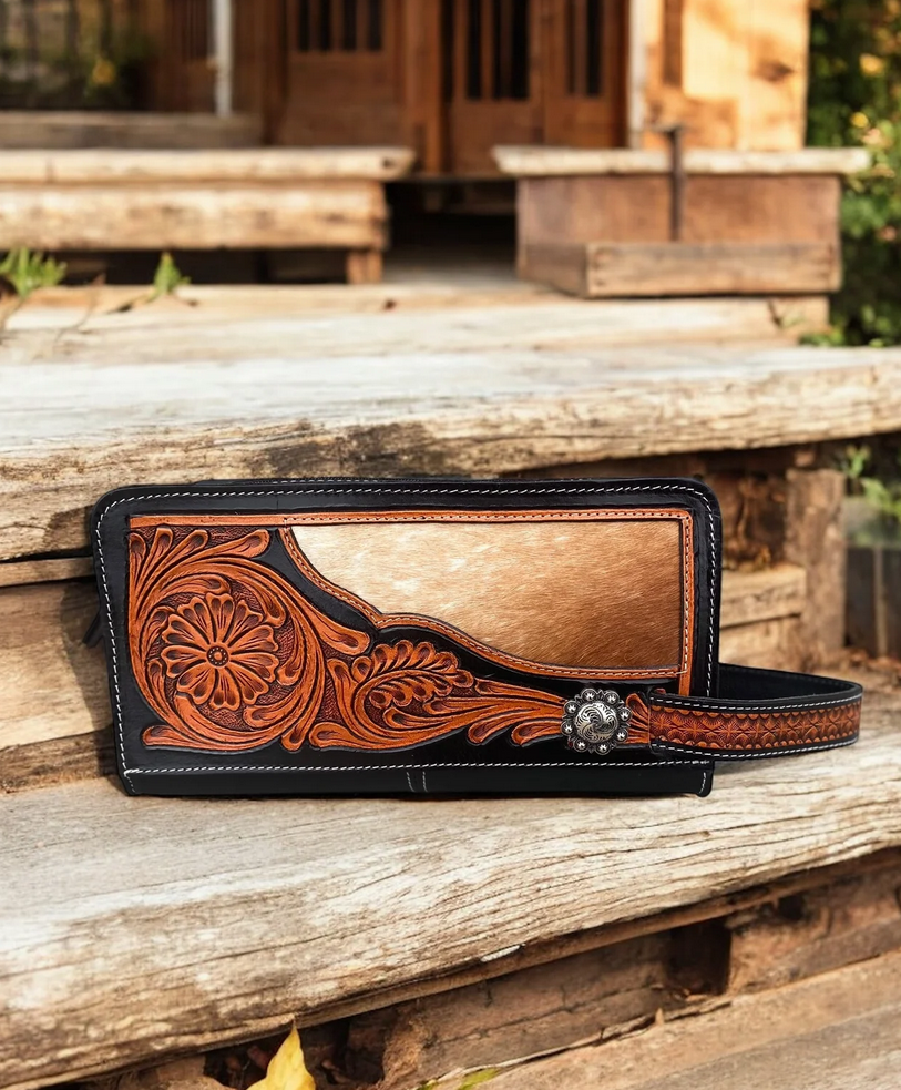 Cowhide and tooled leather toiletry bag with intricate design and durable craftsmanship.