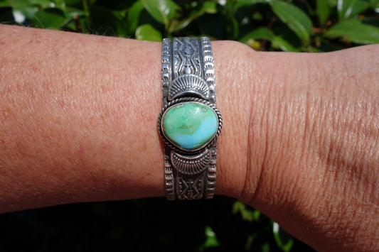 Sterling Silver cuff with blue-green turquoise stone by Native American artist.