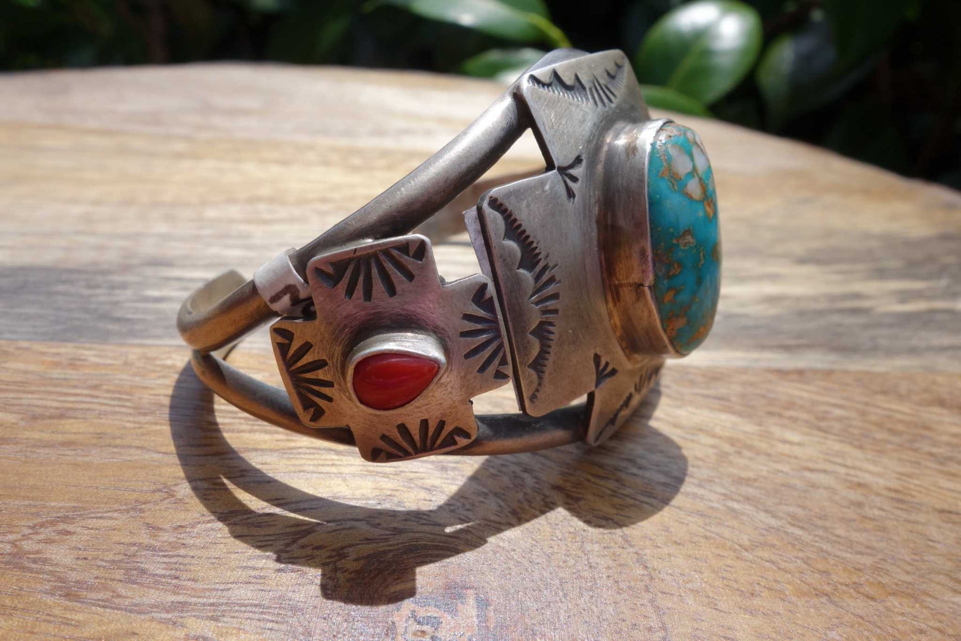 Royston and Coral Cuff with turquoise and coral stones by Randall Endito on wood surface.