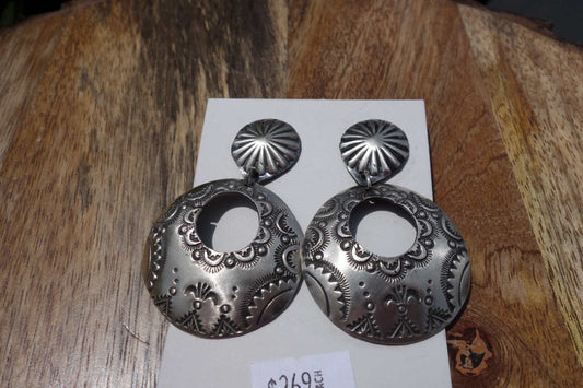 Vincent Platero Earrings silver round engraved dangle earrings on wooden surface