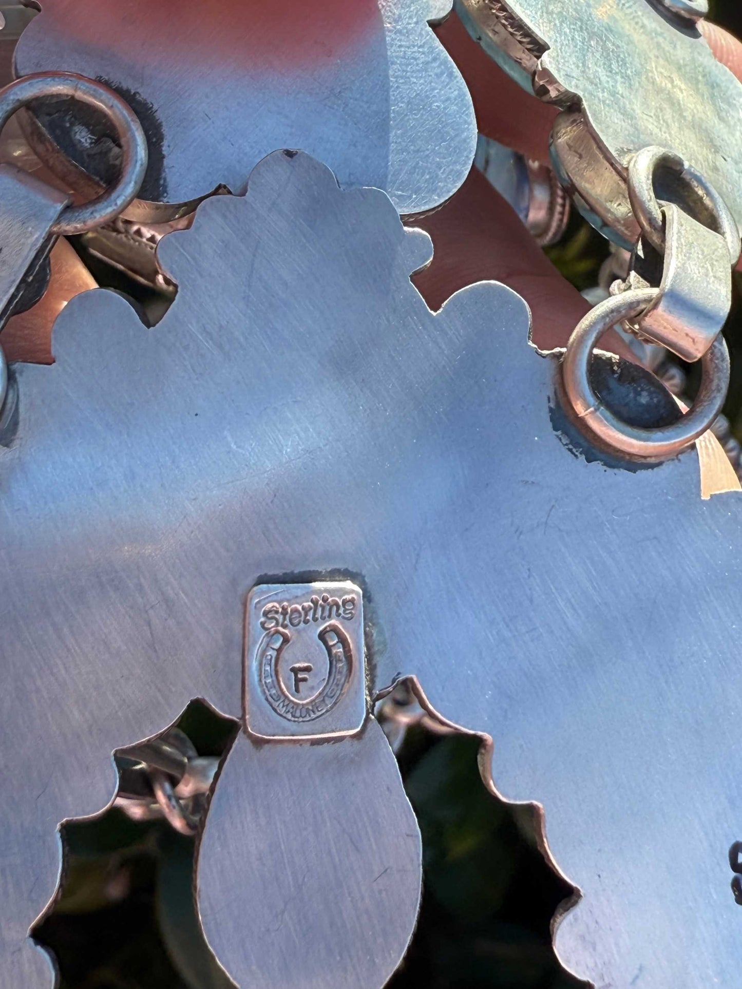 close-up of backside of Golden Hills Squash Blossom statement necklace with sterling silver mark and clasp