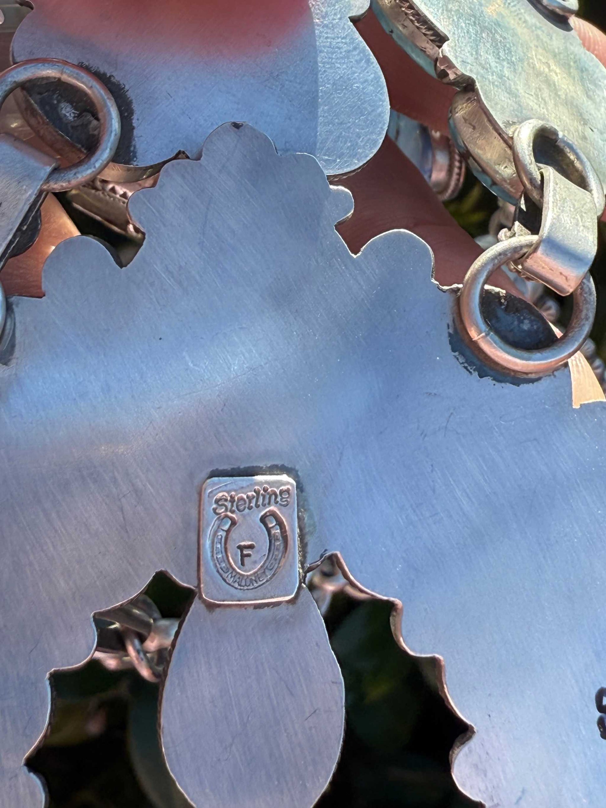 close-up of backside of Golden Hills Squash Blossom statement necklace with sterling silver mark and clasp