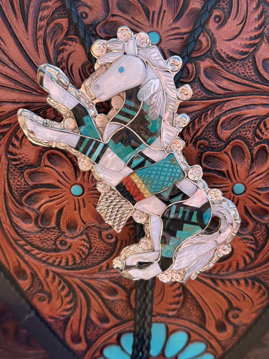 Eldred Martinez Horse Bolo with multi stone inlay and intricate silver design on leather background