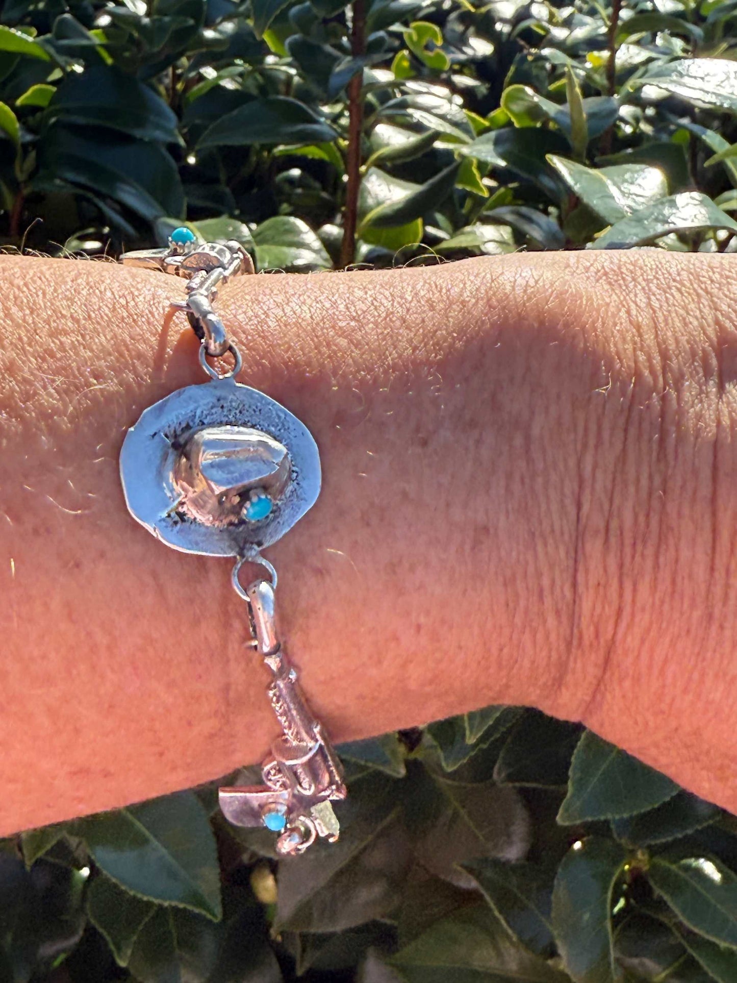 Robby Manuelito Bracelet with sterling silver Western motifs and Sleeping Beauty Turquoise on wrist