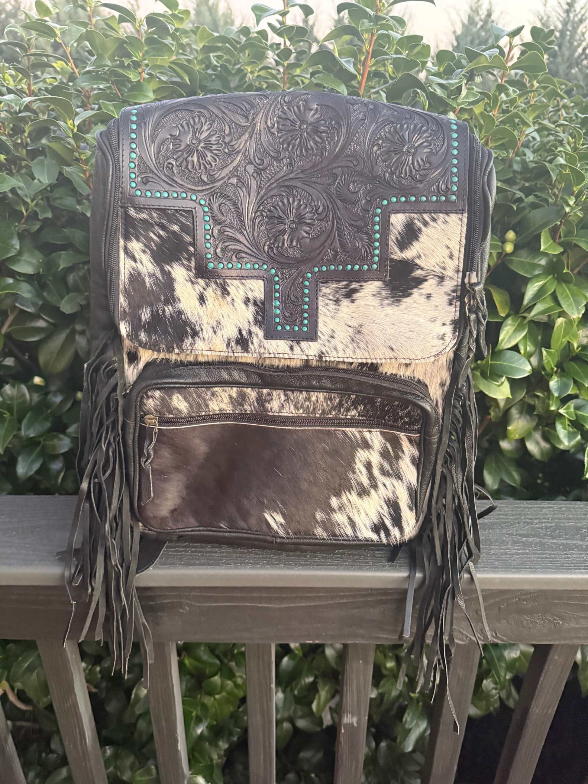 Black tooled leather and cowhide fringe backpack with turquoise accents