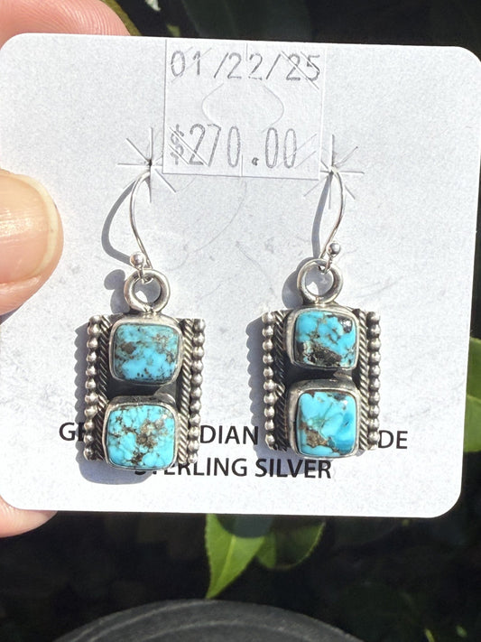 Kingman Turquoise dangle earrings with vibrant blue stones and dark matrix, handcrafted sterling silver Navajo jewelry