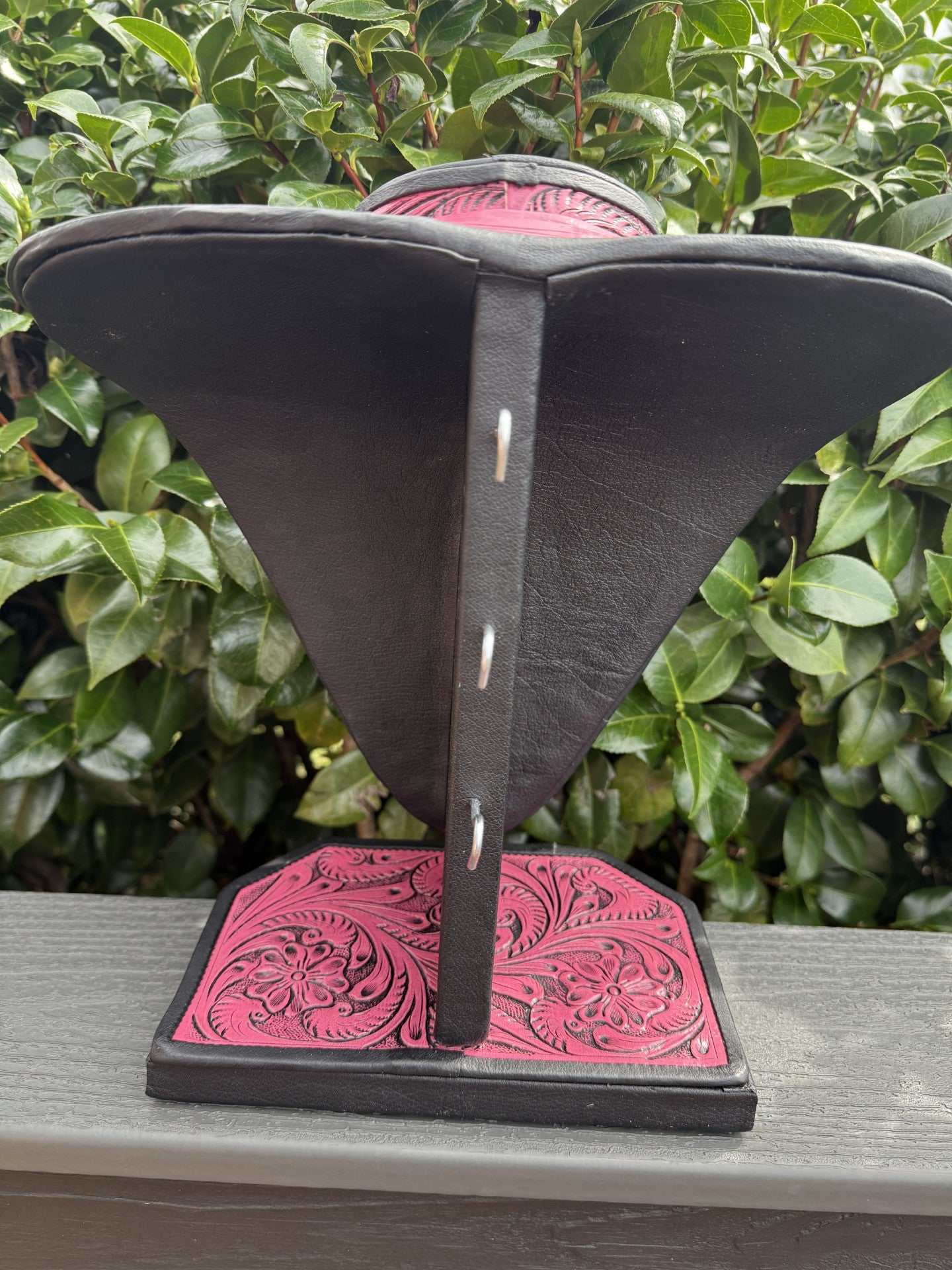 Pink and brown black all tooled leather necklace display for elegant jewelry organization