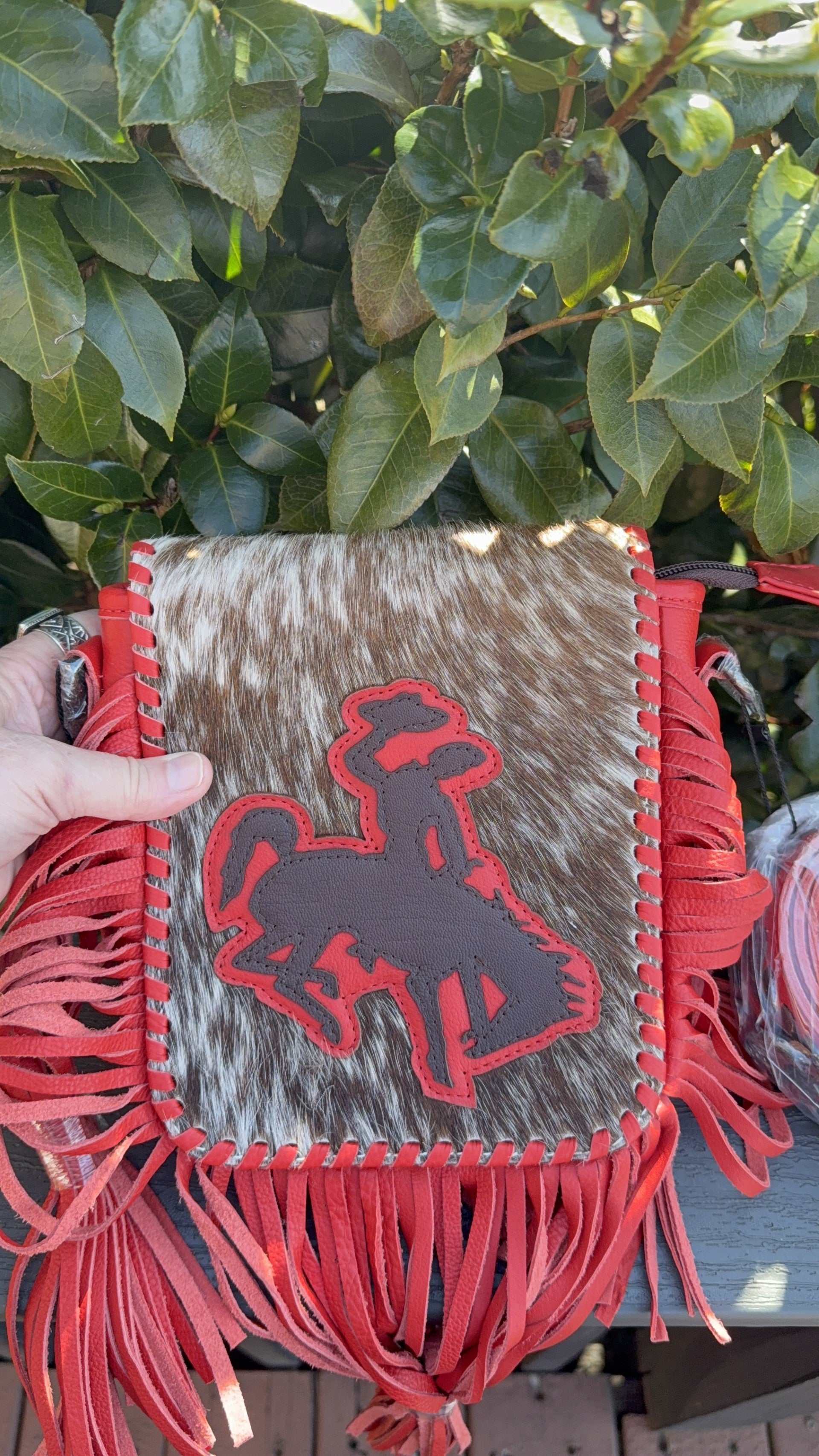 Red bucking fringe crossbody bag with genuine tooled leather and adjustable strap