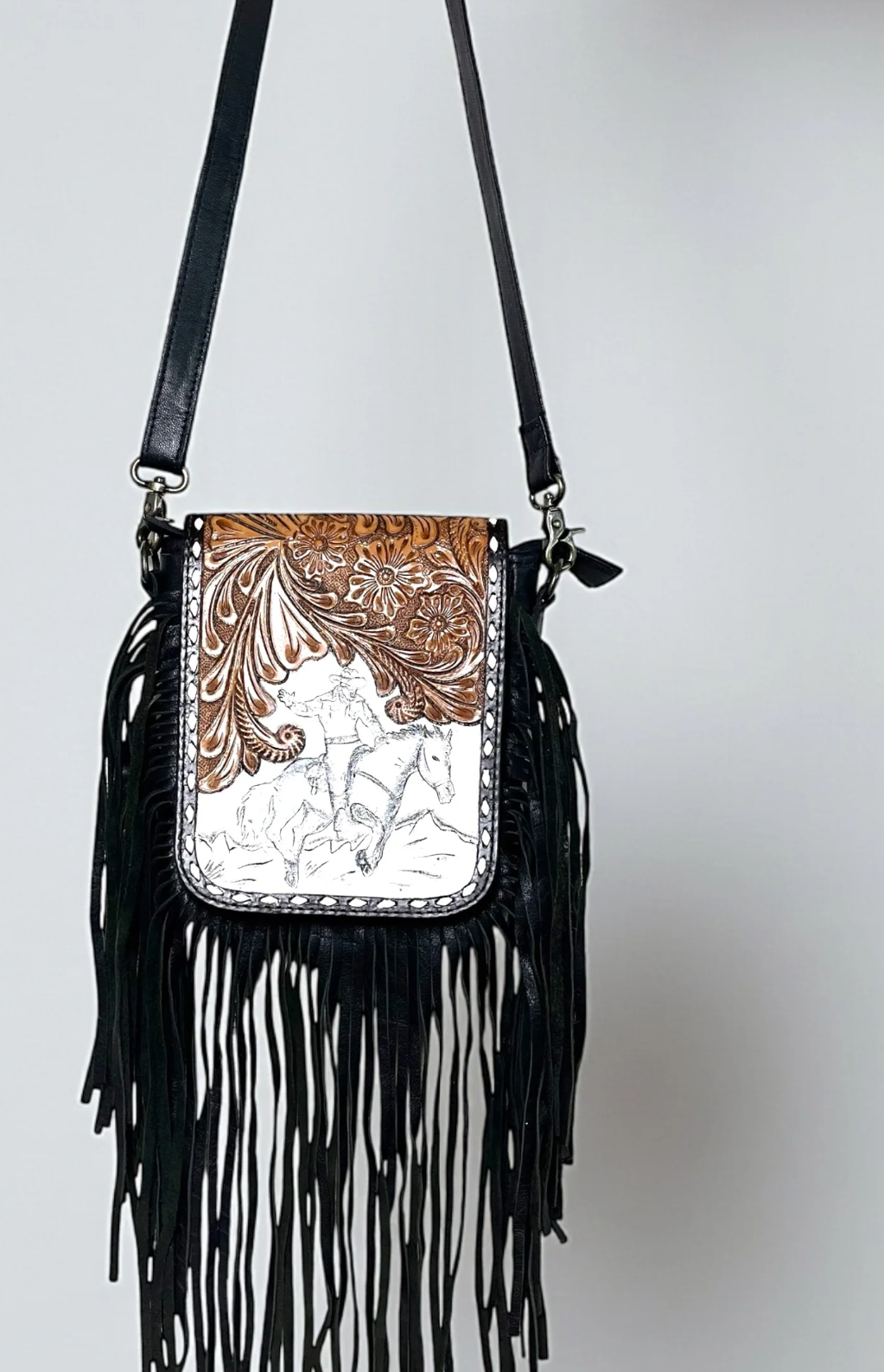 Black tooled leather fringe crossbody bag with Western style and adjustable strap