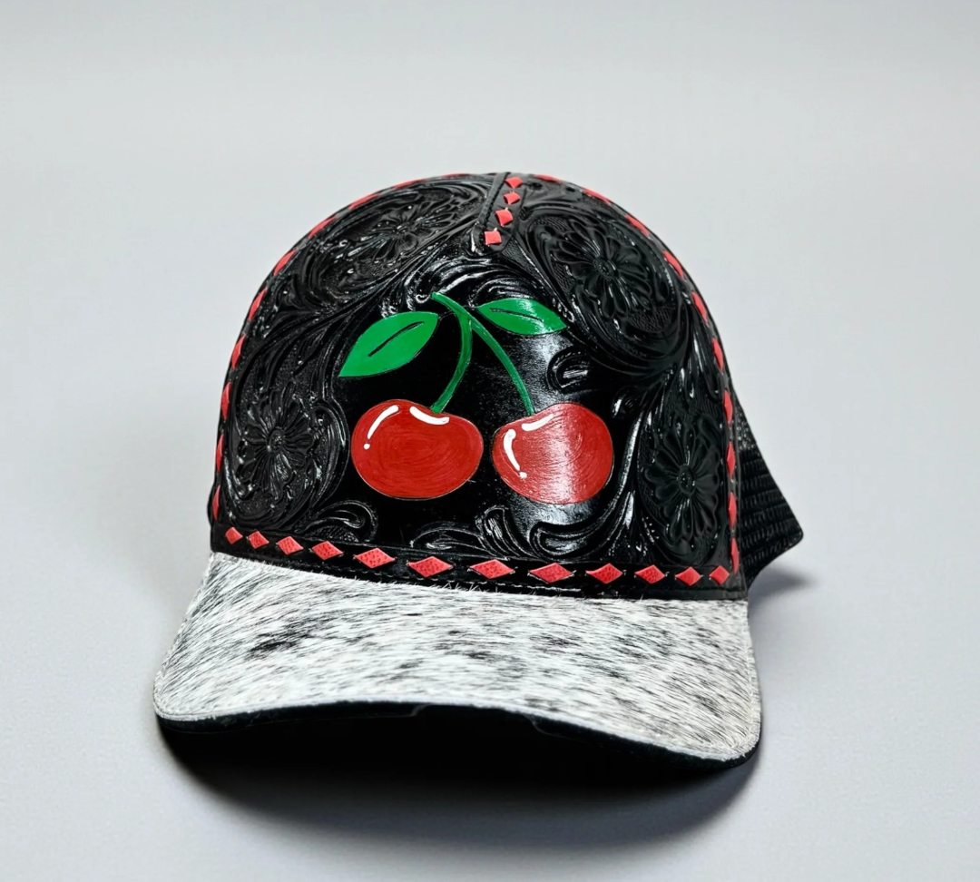 Black Cherry tooled leather and cowhide cap showcasing craftsmanship and style