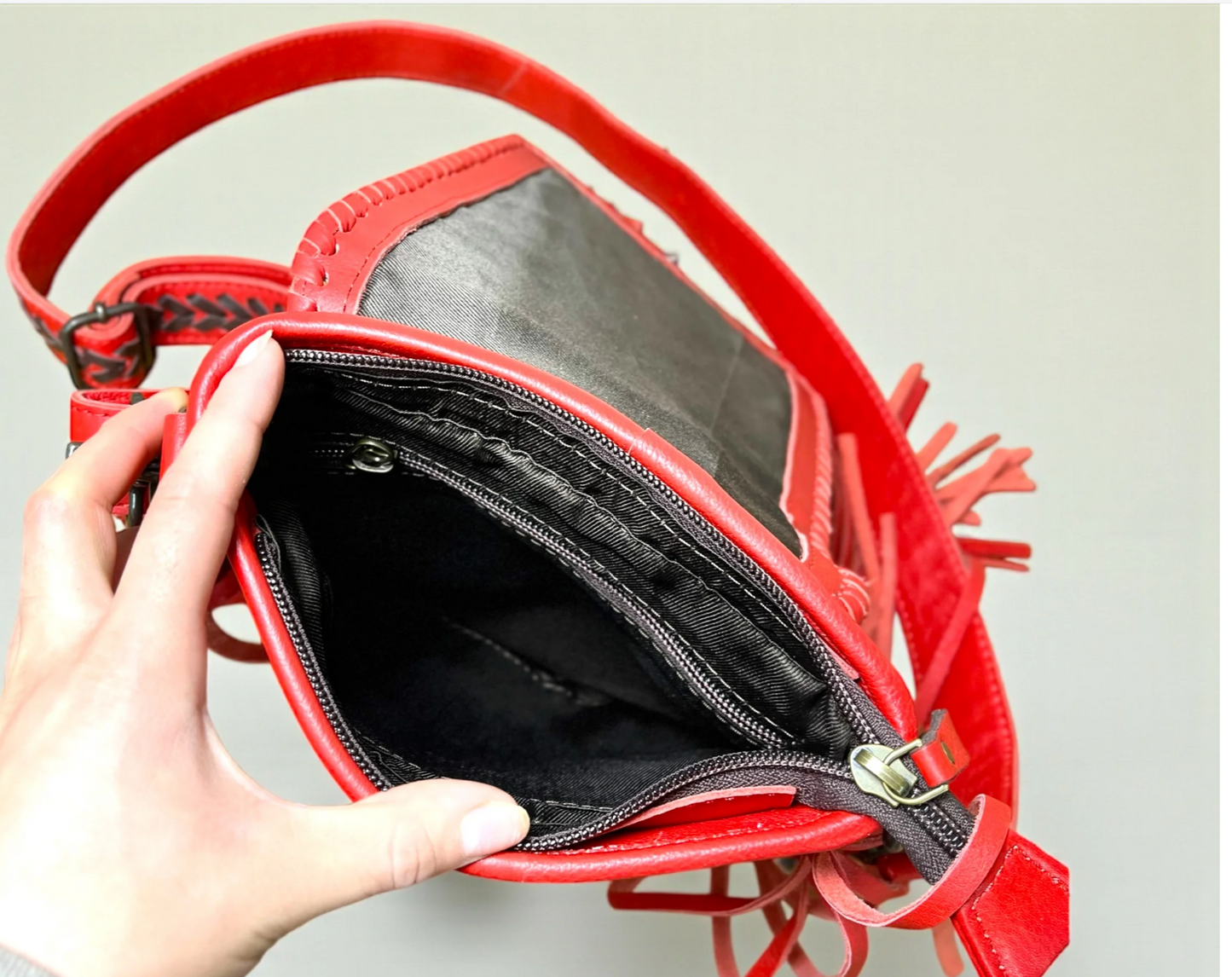 Red bucking fringe crossbody bag with genuine tooled leather and adjustable strap