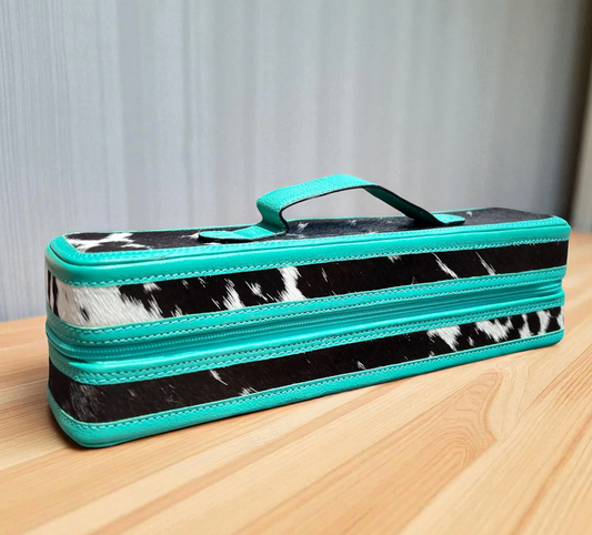 Turquoise leather and cowhide bracelet-cuff box with handle on wooden surface