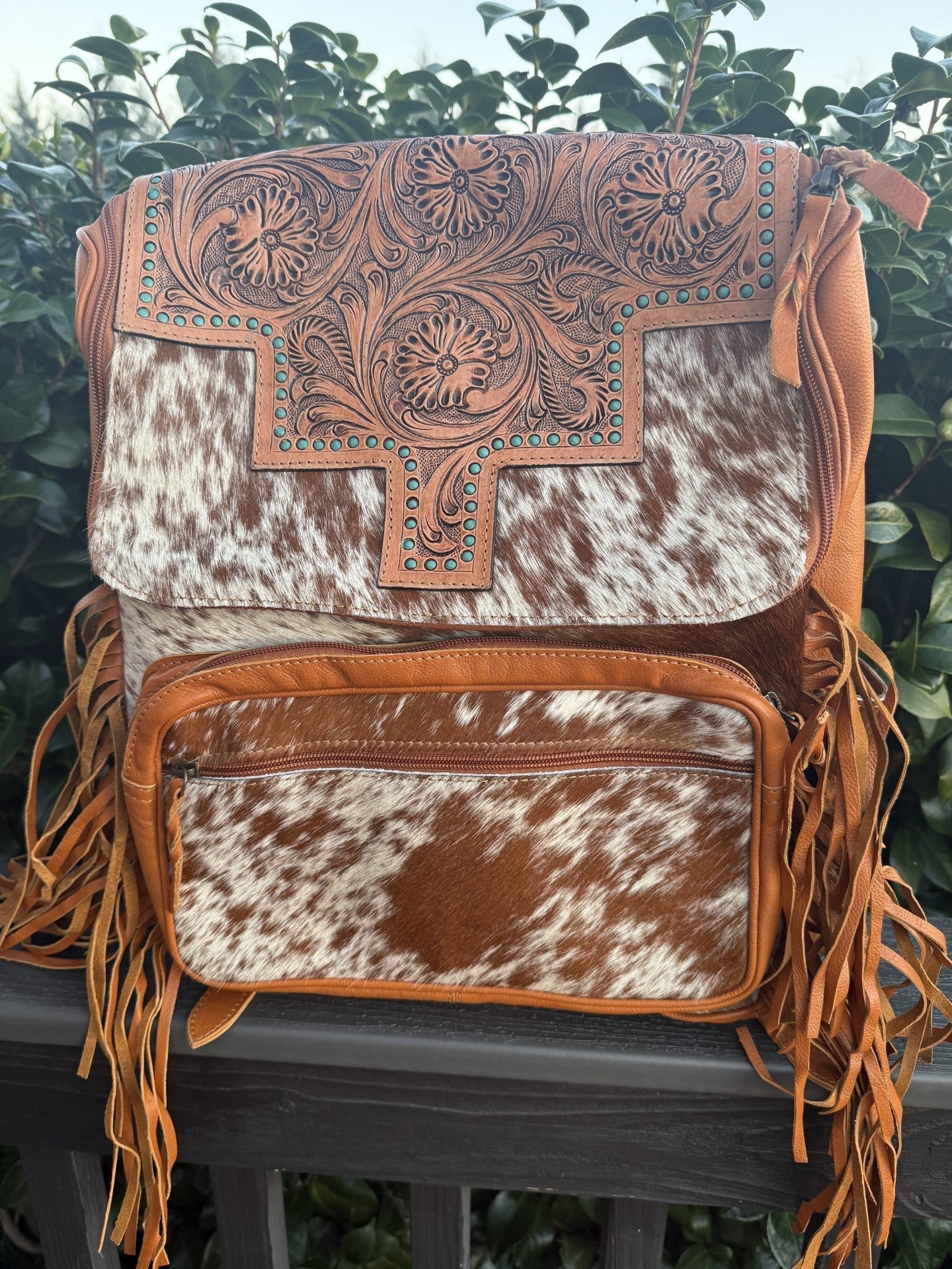 Yellow tooled leather and cowhide fringe backpack with floral designs and turquoise accents