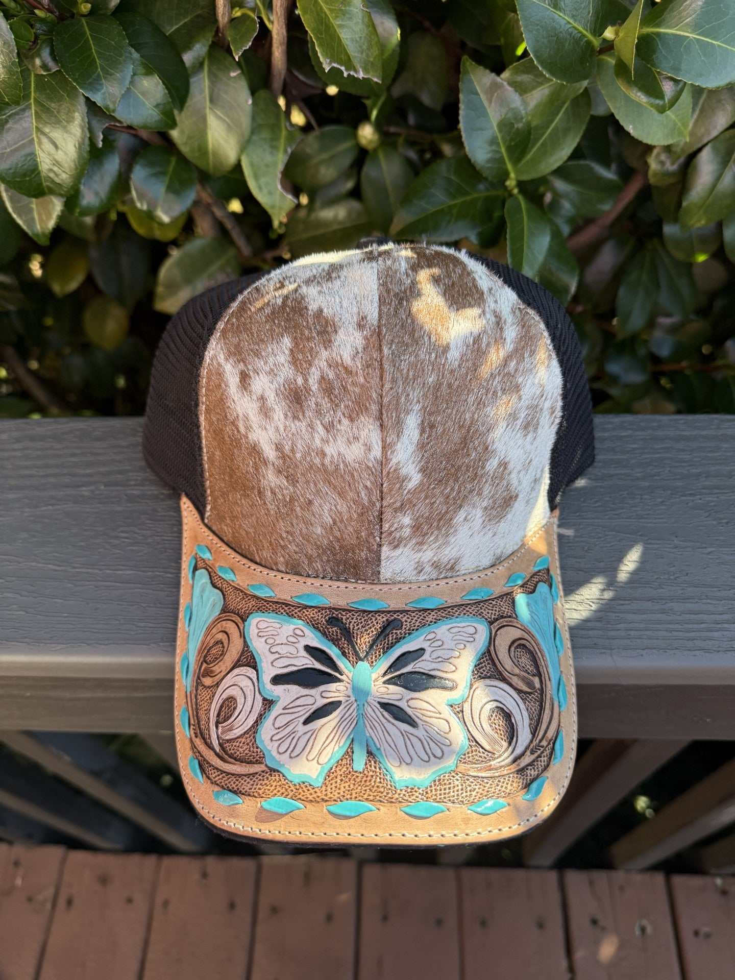 Cowhide tooled leather cap with turquoise butterfly design and adjustable strap