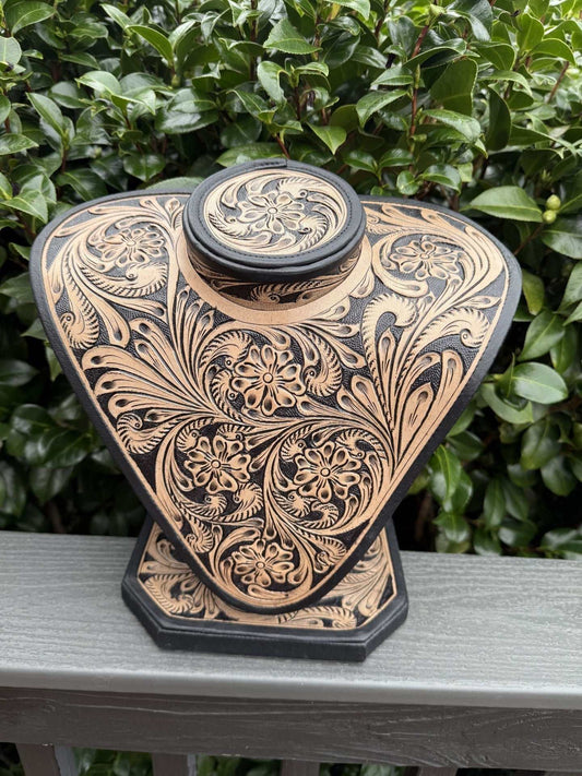 Beige and brown all tooled leather necklace display with intricate floral patterns