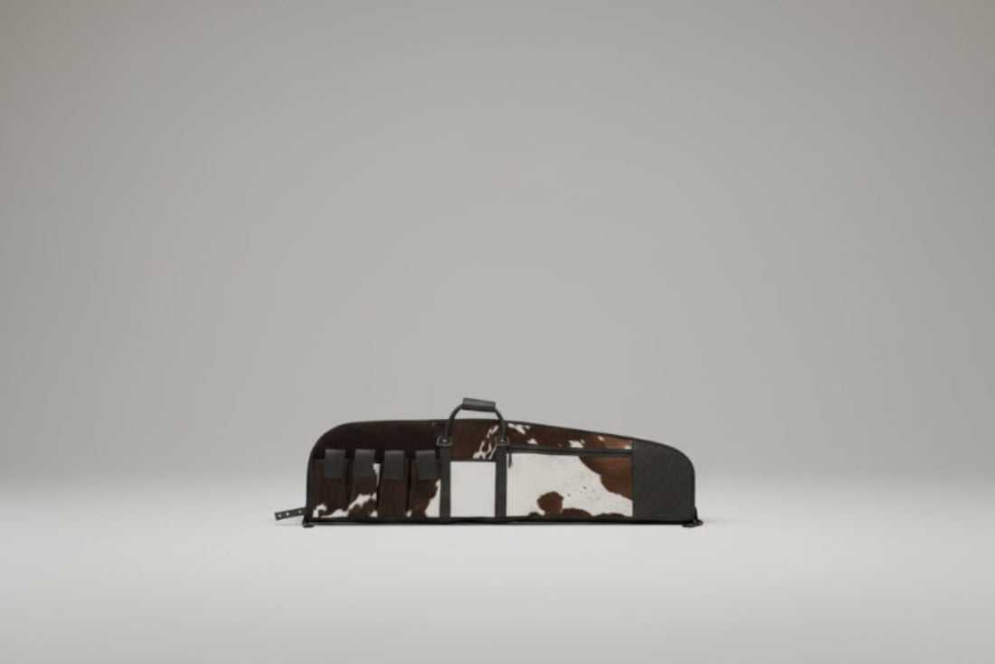 Tooled and cowhide leather rifle case with patchwork design and magazine compartment
