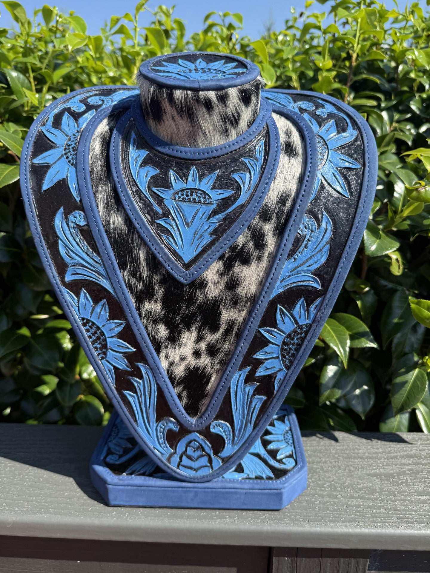 Blue hand tooled leather and cowhide necklace display stand
