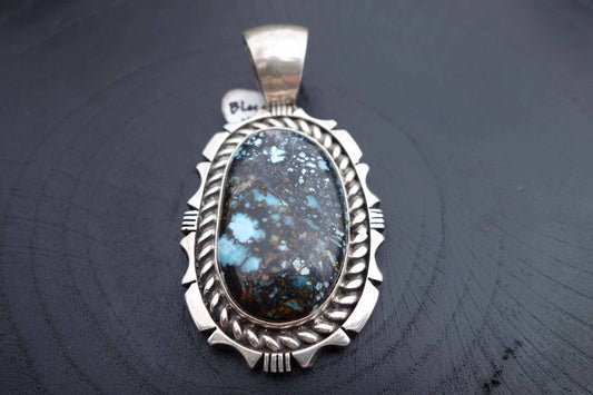Blue moon turquoise pendant with intricate saw work by Eddie Secatero jr