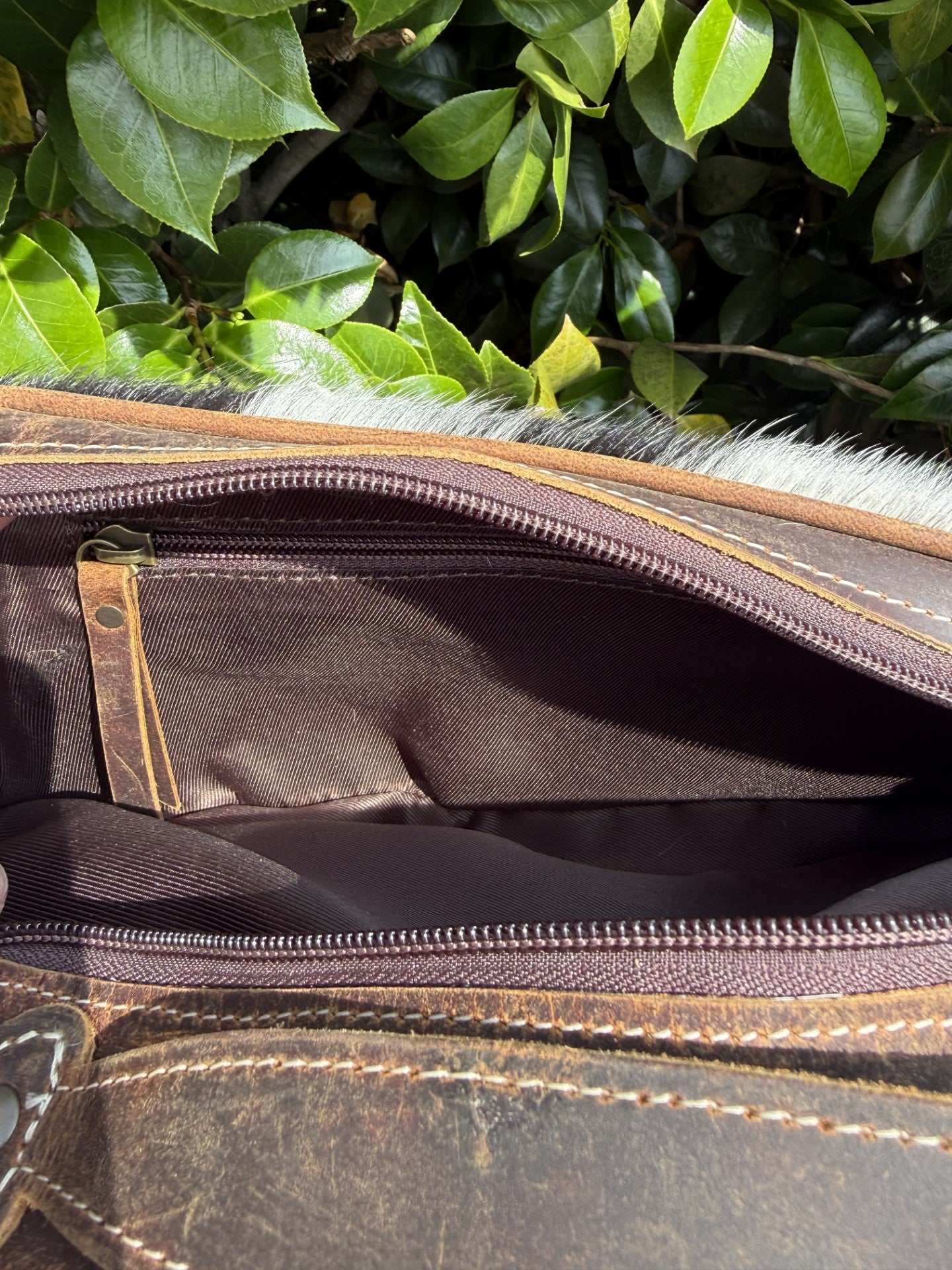 Cowhide and tooled leather toiletry bag with western design and double zipper closure for travel organization