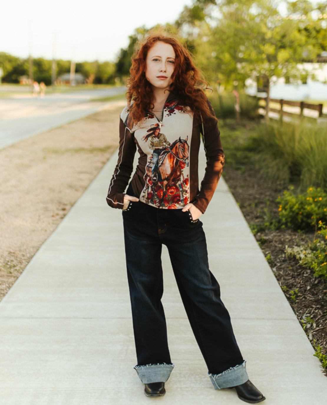 Cowgirl Horse Floral Printed quarter-zip top with a cream cowgirl and horse graphic, red florals, and dark brown sleeves