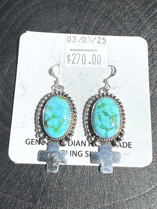 Sterling silver Sonoran Turquoise Earrings with blue-green stones and Zia cross dangle handcrafted by Navajo silversmith.