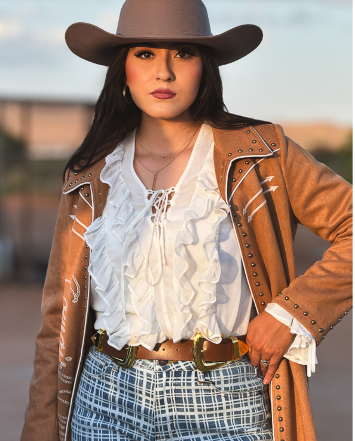 Ivory Long Sleeve blouse with cascading front ruffles, lace-up neckline, sheer fabric and ruffled cuffs