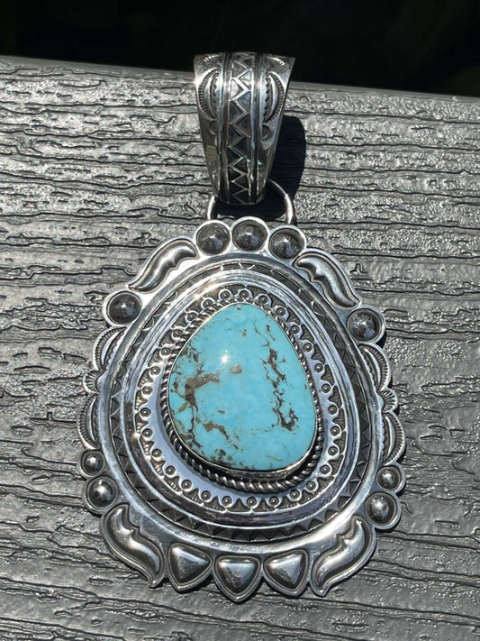 Native American Kingman Turquoise Pendant with intricate silver detailing and teardrop turquoise stone