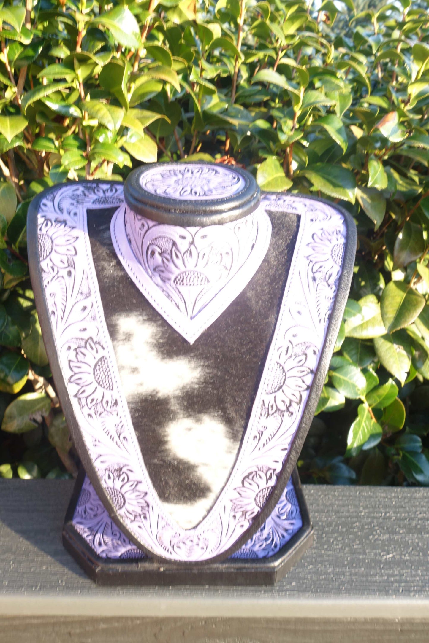 Medium Purple Tooled Leather Necklace Display with black and white cowhide showcasing necklaces