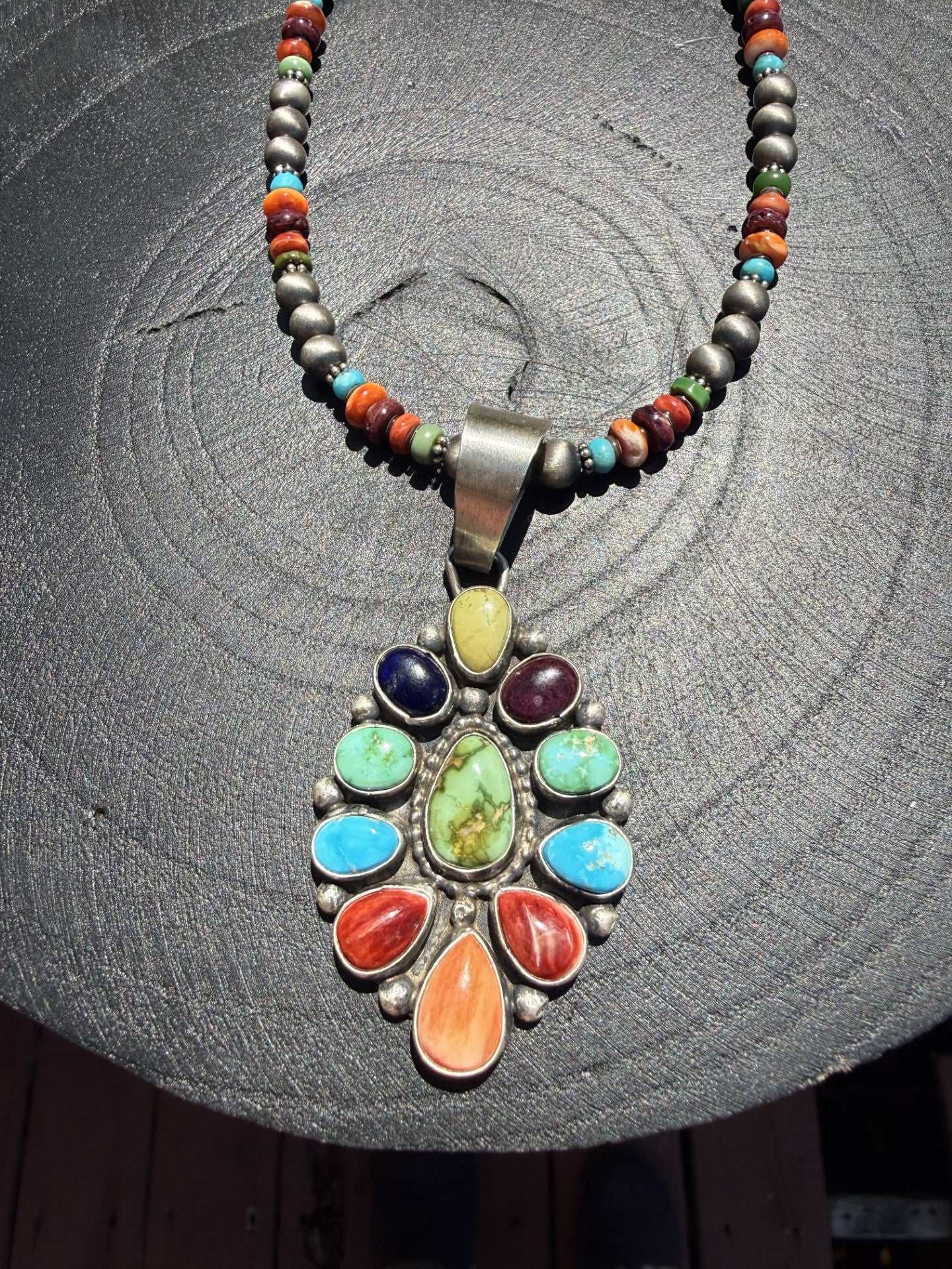Multi stone necklace with colorful stones by Navajo silversmith Travis Jim