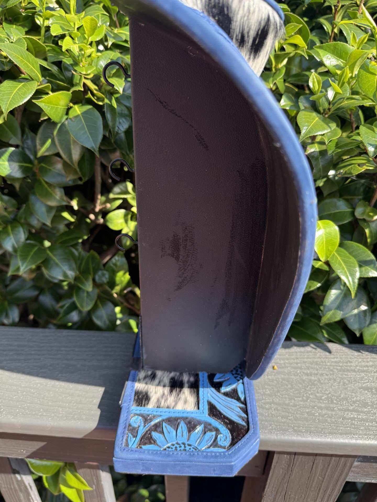 Blue hand tooled leather and cowhide necklace display stand