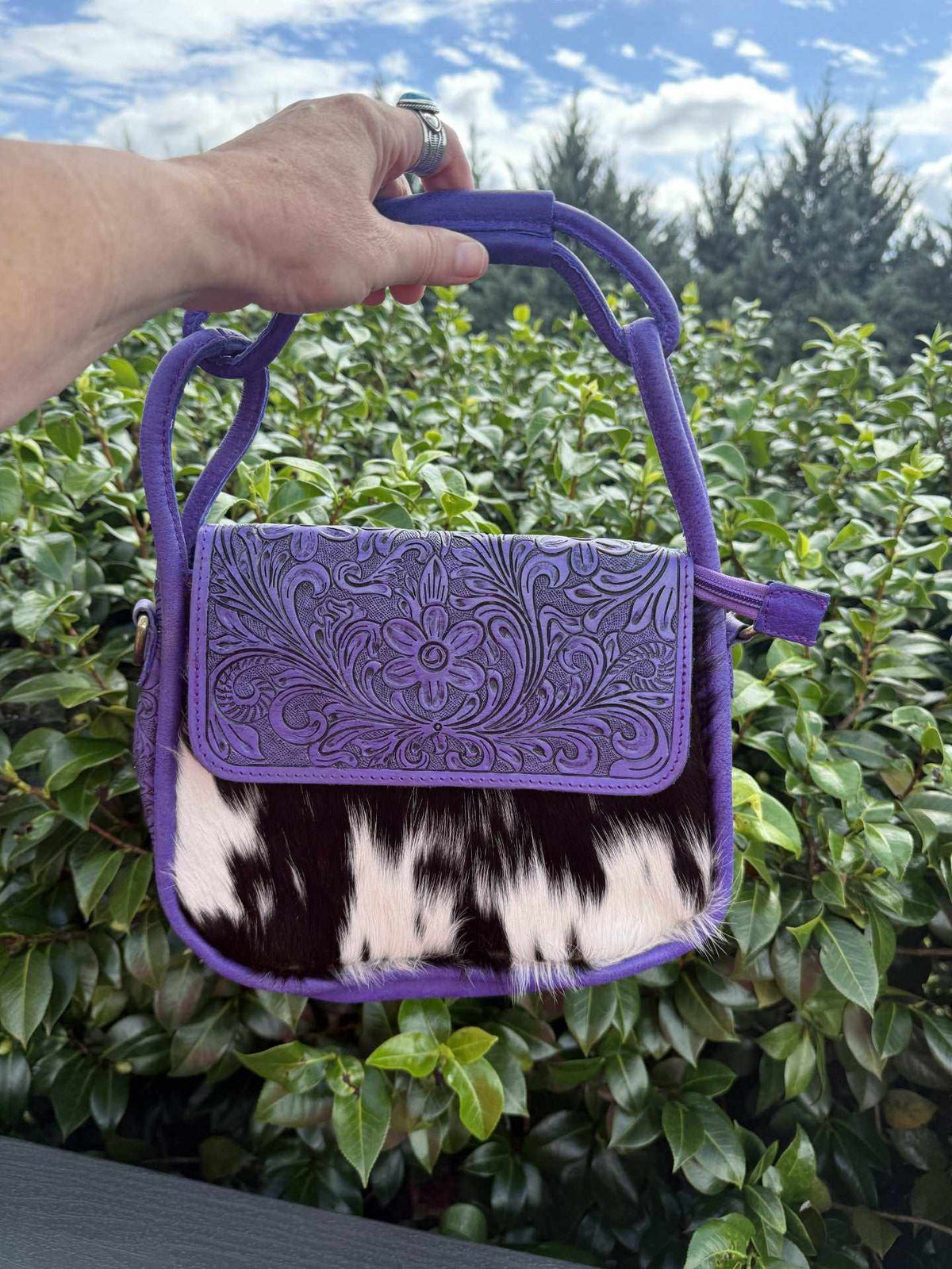 Shoulder bag in Purple tooled leather with embossed floral scrollwork and a black-and-white cowhide panel
