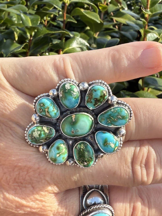 Sonoran Gold Cluster Ring by Shelia Becenti with turquoise and green stones in silver setting worn on hand