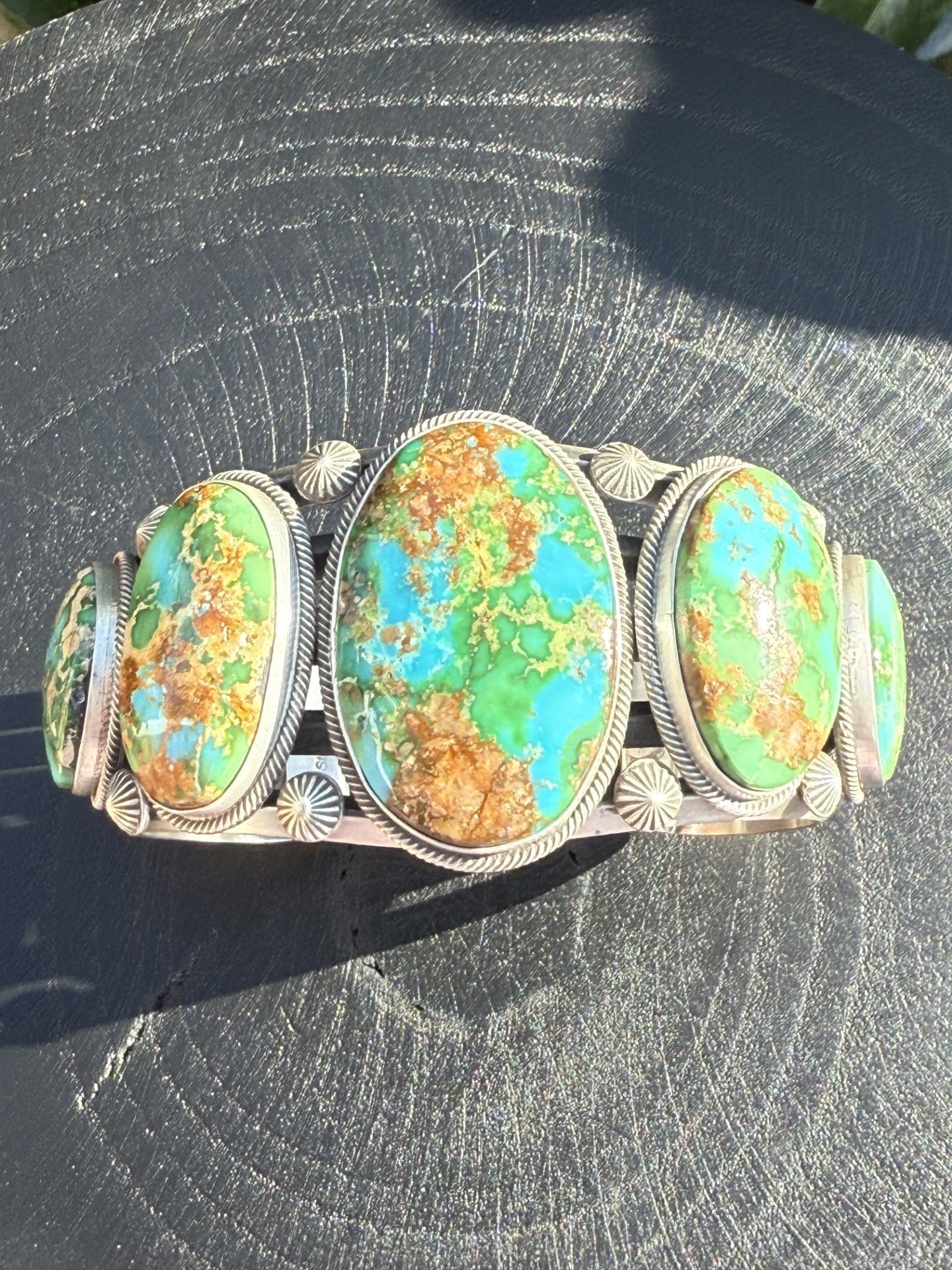 Gorgeous Sonoran Gold Turquoise Cuff with vibrant green, blue, and golden brown stones handcrafted by Navajo artist Feddie Meloney