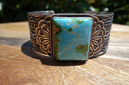 Sterling Silver Square cuff with intricate etched patterns and a large blue-green Sonoran gold turquoise stone centerpiece